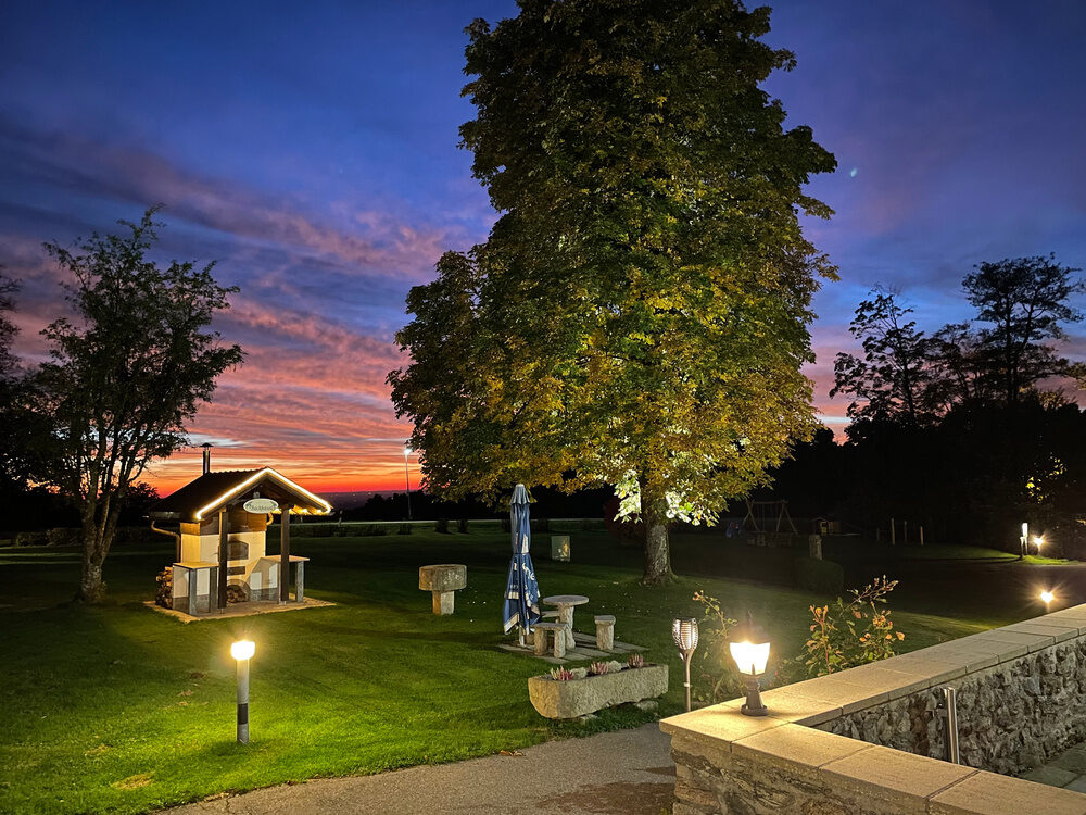 Der Garten des Hotels bei Sonnenuntergang beleuchtet durch Laternen
