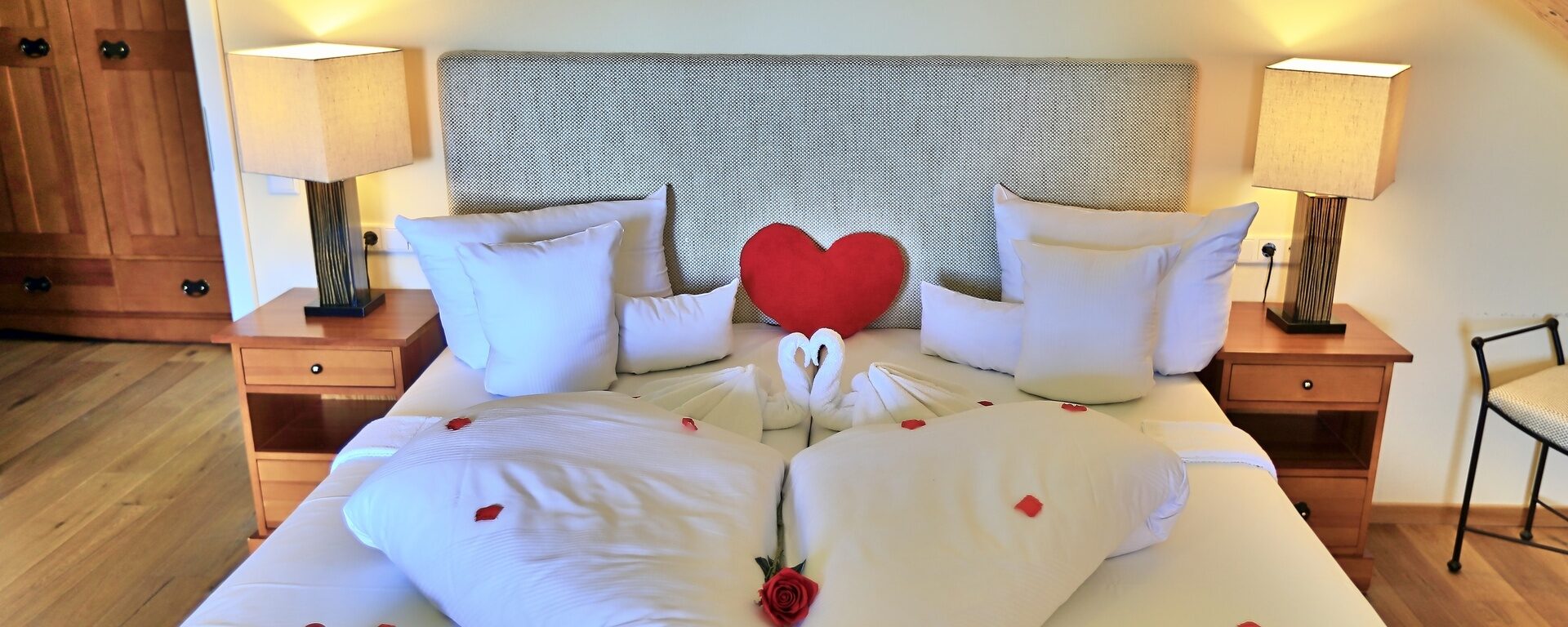 Ein romantisch angerichtetes Bett im Hotel Gut Schmelmerhof in Sankt Englmar.